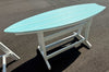 Outdoor surfboard table with turquoise top and white base, weather-resistant patio furniture with coastal design