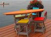 Outdoor surfboard table with colorful chairs on wooden dock by water